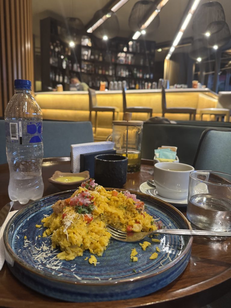 Plate of yellow rice with shrimp and salsa criolla at the DoubleTree Iquitos restaurant bar